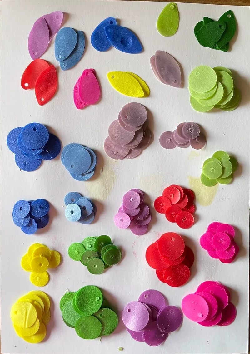 Circular and petal-shaped Bequin samples in a range of colours