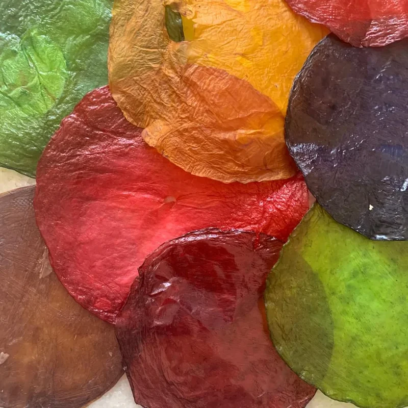 Overlapping translucent material samples in green, orange and red