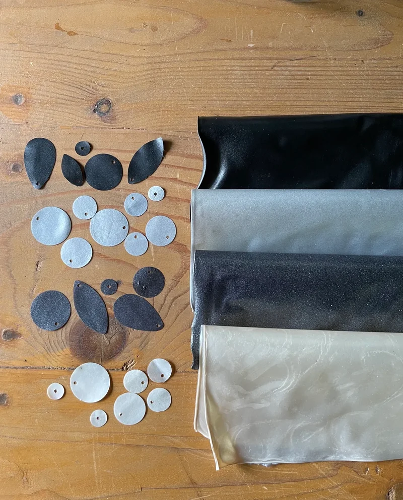 Material sheets and cut samples arranged for colour comparison